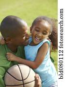 African American father hugging daughter