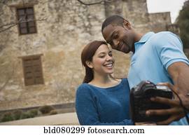 Couple taking self-portrait with digital camera