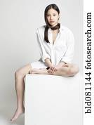 Chinese woman sitting barefoot