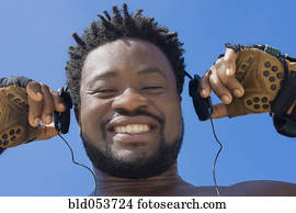 African man holding headphones
