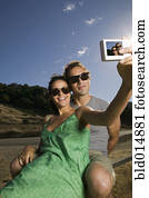 Couple taking self-portrait with camera