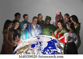 Multi-ethnic people in traditional dress looking at globe