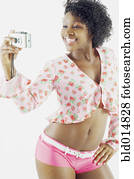 Woman taking self portrait with camera