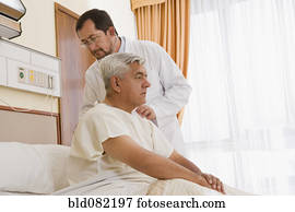 Doctor examining patient in hospital room