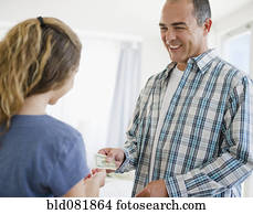 Hispanic father handing daughter money