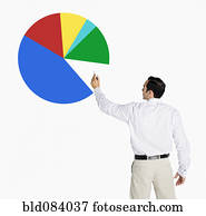 Hispanic businessman drawing pie chart on board