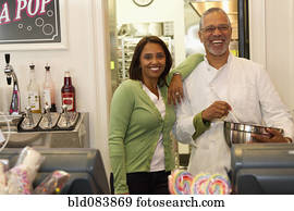 Small business owners standing in bakery shop