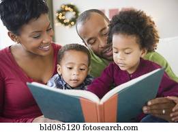 Black family reading book together