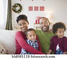 Black family relaxing on sofa together