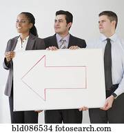 Business people holding whiteboard with arrow