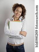 Mixed race woman holding books