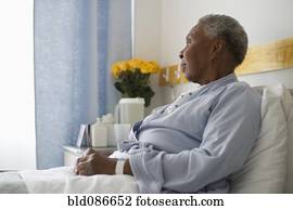 Black woman recovering in hospital bed Black woman recovering in hospital bed