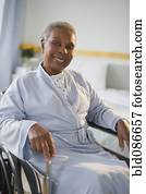 Black woman sitting in wheelchair in  hospital