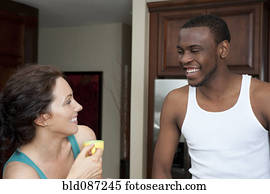 https://cdn-grid.fotosearch.com/BLD/BLD070/husband-smiling-at-wife-in-kitchen-stock-photography__bld087245.jpg