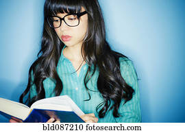 Mixed race woman reading book