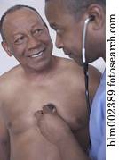 African American male doctor examining patient
