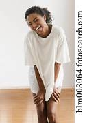 African woman laughing in large t-shirt