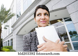 Cape Verdean businesswoman holding tablet computer outdoors