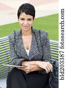 Cape Verdean businesswoman using tablet computer outdoors