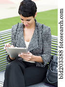 Cape Verdean businesswoman using tablet computer outdoors