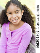 Cape Verdean girl smiling on park bench
