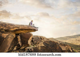 Caucasian woman sitting on rock formation