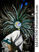 Dancer wearing feather headdress in performance