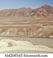 Empty Bench in Desert Landscape