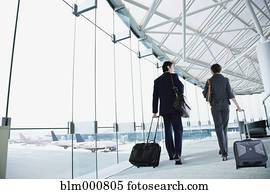 Multi-ethnic business people walking in airport