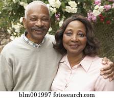 Senior African couple hugging and smiling outdoors Senior African couple hugging and smiling outdoors