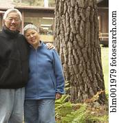 Senior Asian couple hugging and smiling outdoors