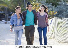 Friends walking on beach