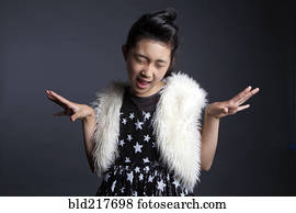 Asian girl dancing in furry vest