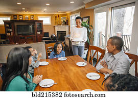 Black family celebrating birthday at table