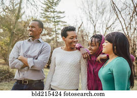 Black family smiling outdoors