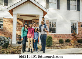 Black family smiling outside house