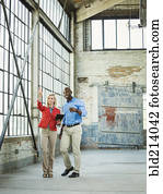 Business people using digital tablet in warehouse