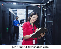 Business people working in server room