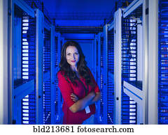 Caucasian businesswoman smiling in server room