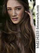 Caucasian woman with long hair and freckles