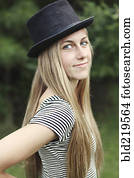 Smiling woman wearing top hat outdoors
