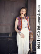 Stylish woman wearing vest and dress