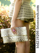 Woman in shorts carrying purse