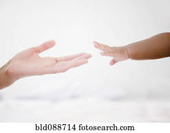 African American woman reaching out to baby boy