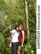 Hispanic couple talking self-portrait in forest