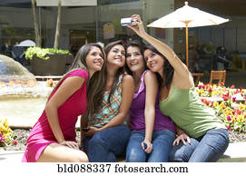 Hispanic friends taking self-portrait