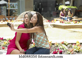 Hispanic friends taking self-portrait