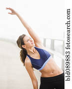 Hispanic woman stretching before exercise