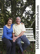 Senior Hispanic couple sitting on park bench Senior Hispanic couple sitting on park bench