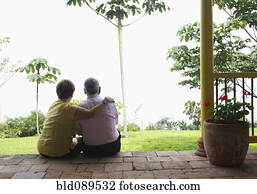 Senior Hispanic couple sitting outdoors together Senior Hispanic couple sitting outdoors together